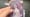 A hand holding a Rumi SSR card from Kayou's KPop Demon Hunters Collectible Trading Cards