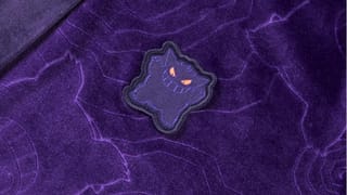 A close up of the Gengar badge from the Gengar Purple Sleep Robe on the Pokemon Center website